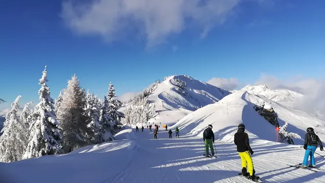 Dorfgastein - Großarltal: лыжники на склоне зимой