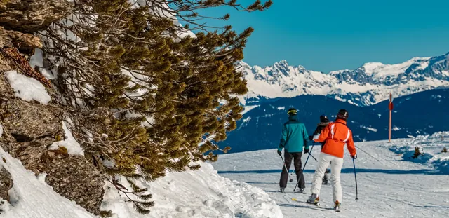 Beautiful alpine winter wonderland with passing by ski drivers at Flachau, Salzburg, Austria