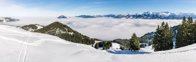 Amazing panoramic View from Snow Mountain to snowy Mountain Range above foggy cloud layer. Sea of clouds. Rangiswangerhorn, Allgau, Bavaria, Germany.