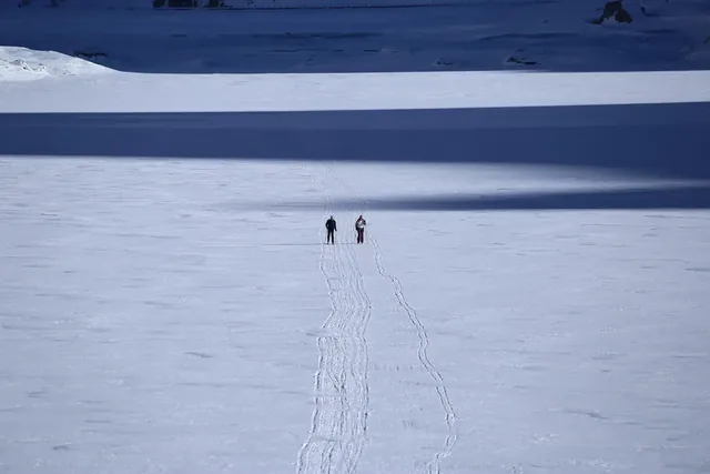 Passo Fedaia, Italy - People practicing cross country skiing over the frozen Fedaia lake