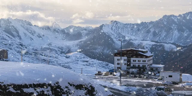 Snowflakes and beautiful view of accommodation on Passo dello Stelvio, Bormio Italy.