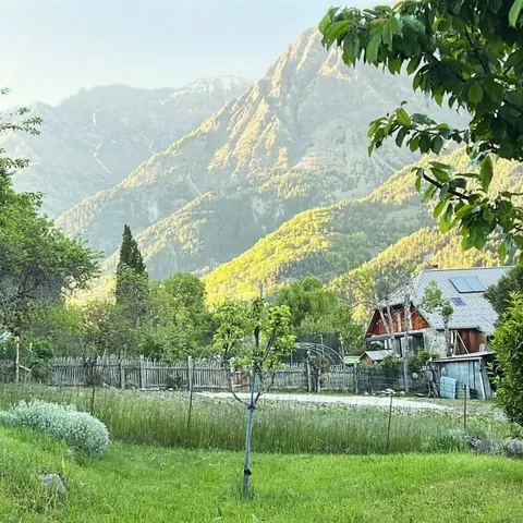 House with garden near the lake with mountain view